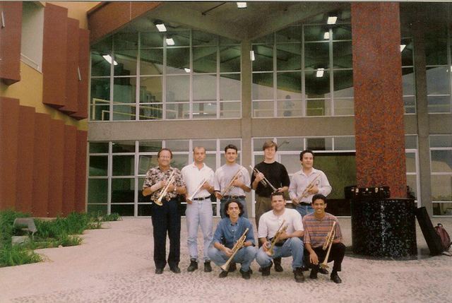 Luis Engelke with brass students outside a university building