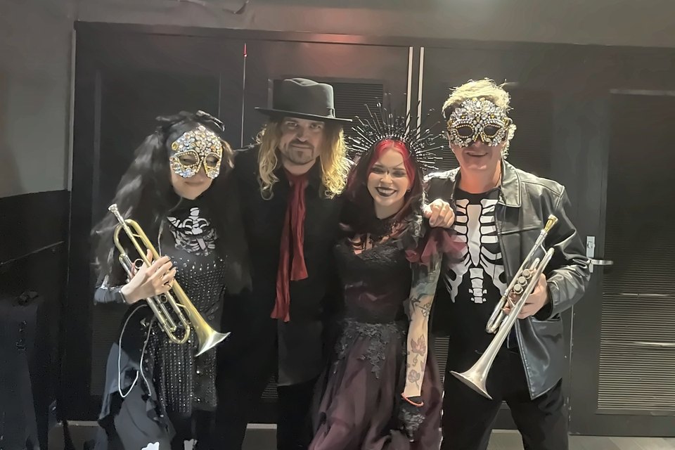 Luis Engelke backstage with three costumed stars of the Rock Orchestra by Candlelight